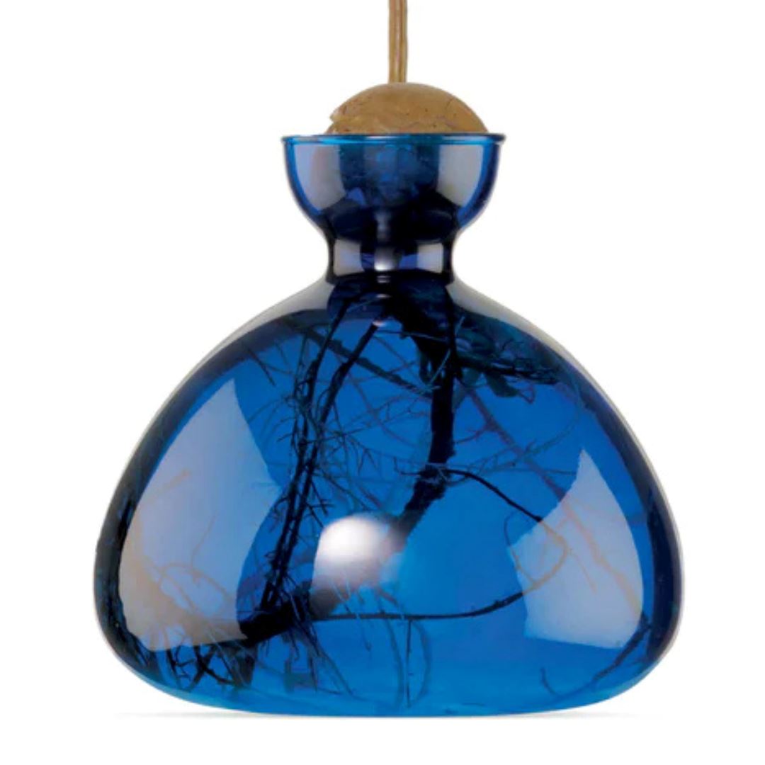 Blue glass acorn-shaped ornament with cork top and hanging cord.