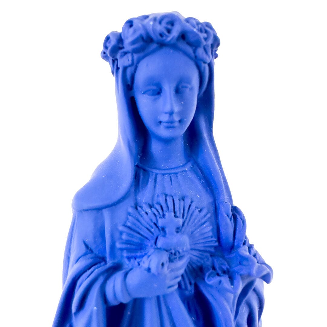 Matte dark blue Madonna statue with a floral crown holding a heart and roses.